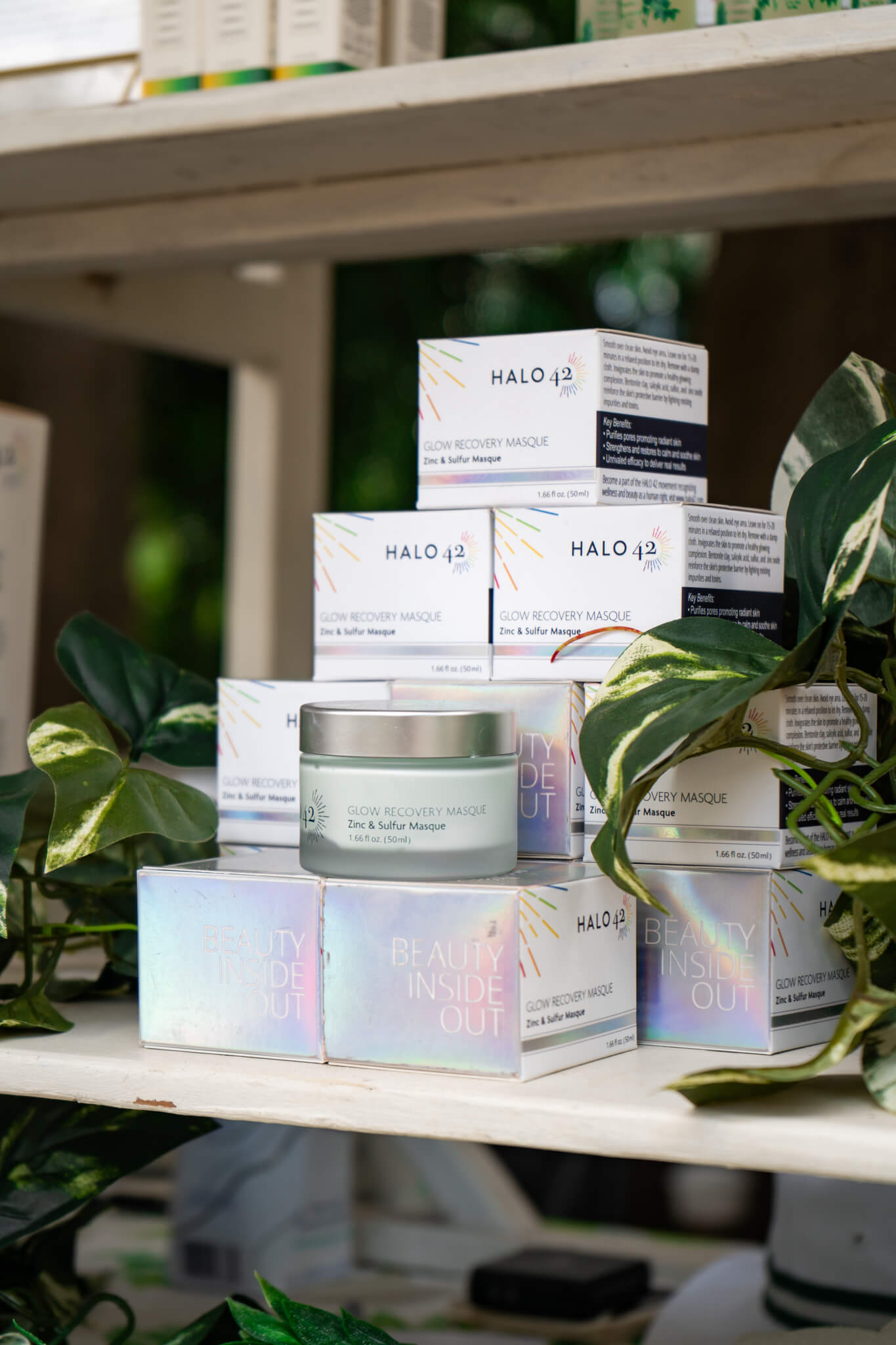 Halo42 skincare Products on shelf with glimmering rainbow packaging