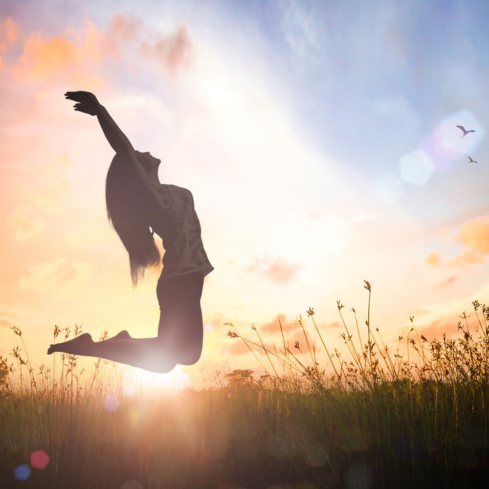 Woman Jumping into sunrise